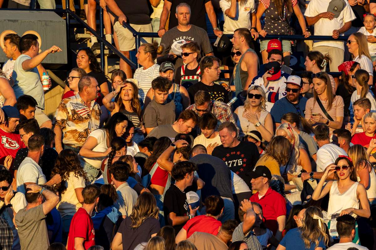 The crowd reacts after an errant firework exploded among attendees during Stadium of Fire held at LaVell Edwards Stadium in Provo, Utah, on Thursday, July 4, 2024. Several people were injured when fireworks misfired and struck members of the audience inside the football stadium, police said.