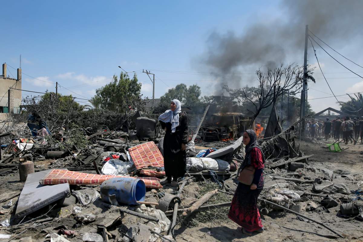 Palestinians inspect the damage at a site hit by an Israeli bombardment on Khan Younis, southern Gaza Strip, Saturday, July 13, 2024.
