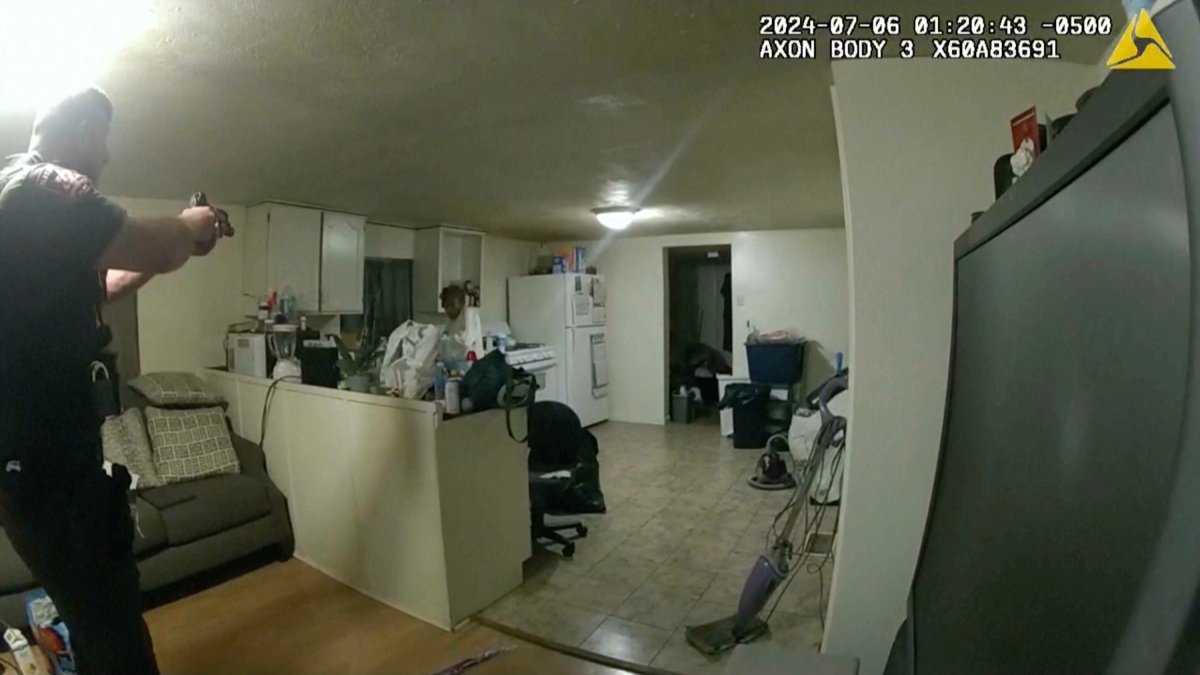 In this image taken from body camera video released by Illinois State Police on Monday, July 22, 2024, former Sangamon County Sheriff’s Deputy Sean Grayson, left, points his gun at Sonya Massey, who called 911 for help, before shooting and killing her inside her home in Springfield, Ill., July 6, 2024.