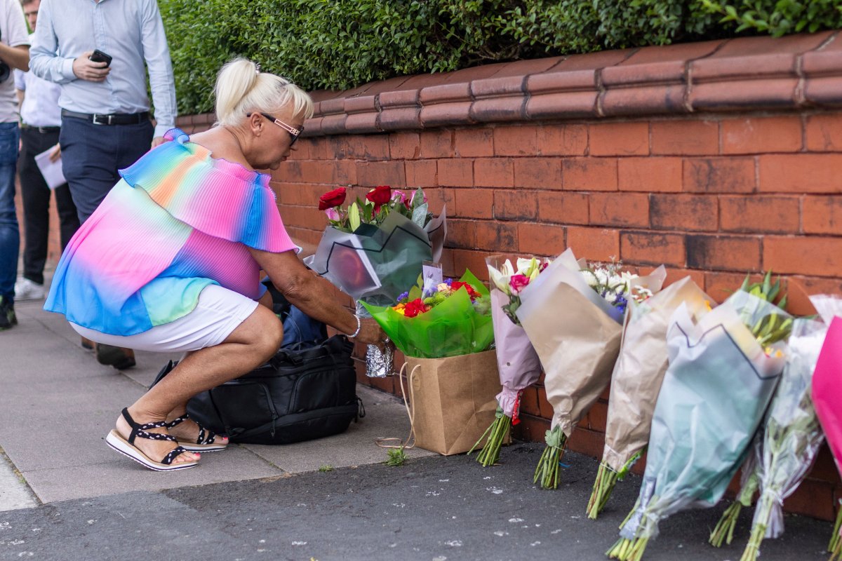 A person leaves flowers near the scene in Hart Street, Southport, Britain, on Tuesday. Three children died and nine were injured in a ‘ferocious’ knife attack during a Taylor Swift event at a dance school on Monday.