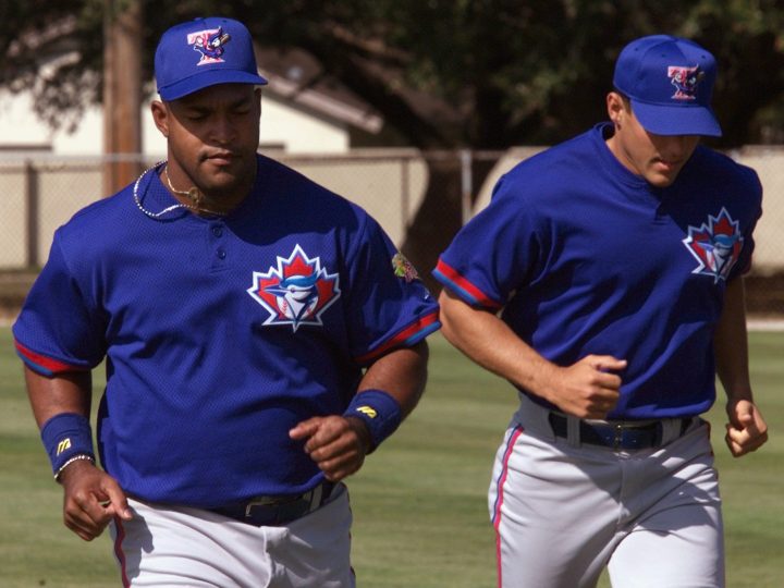Toronto Blue Jays outfielder Raul Mondesi, left, runs with infielder Alex Gonzalez at spring training in Dunedin, Florida on Tuesday, Feb. 22 , 2000.