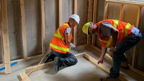 Two members of The Carpenter's Crew work on a new home in Fergus.