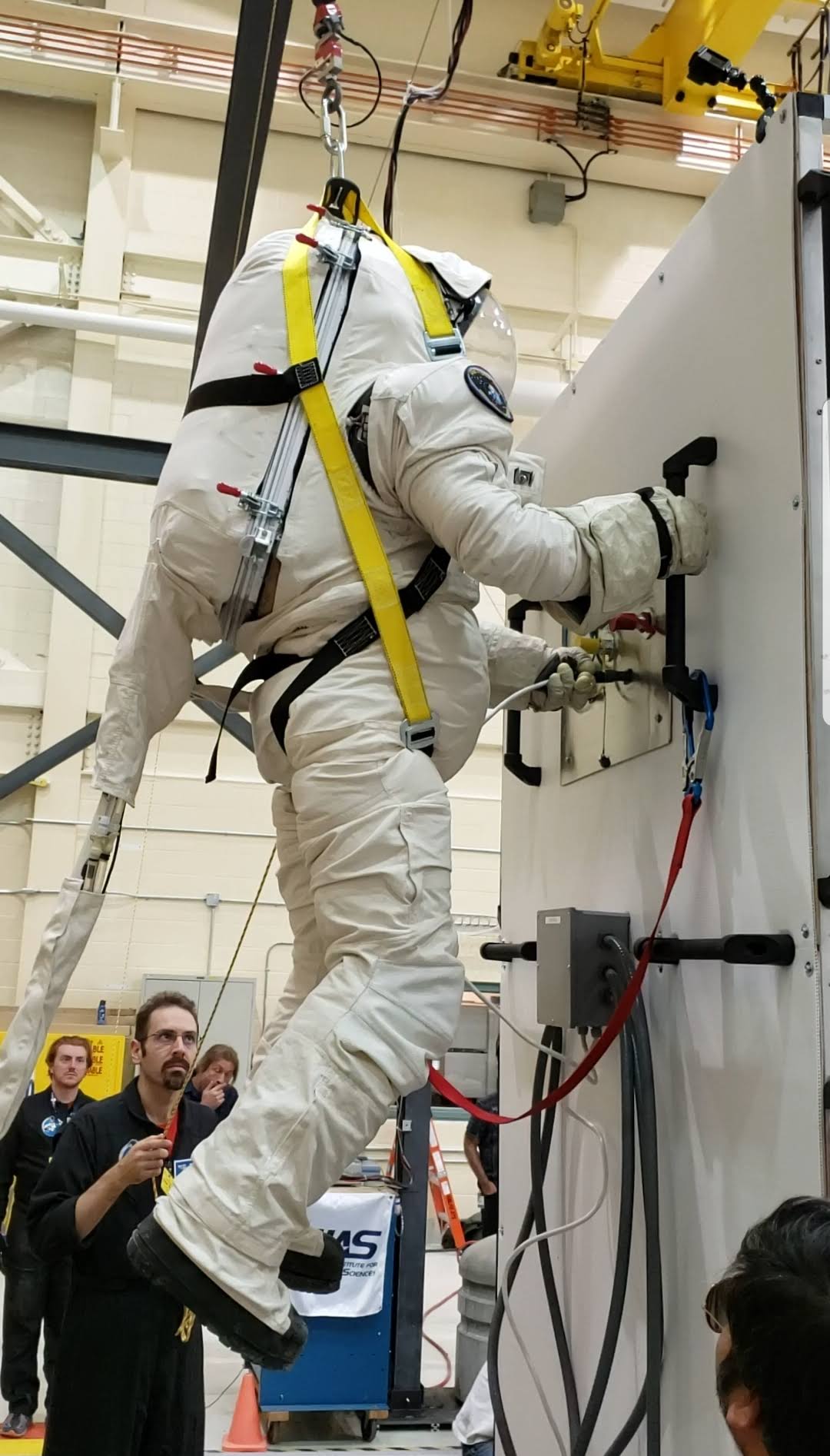 Dr. Shawna Pandya tests the Final Frontier Design EVA (extra-vehicular activity) spacesuit in a gravity offset system in the Canadian Space Agency's High Bay during the 2019 Project PoSSUM gravity offset course