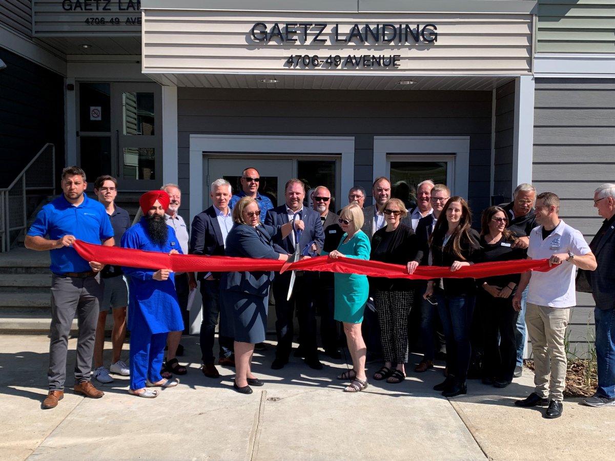 Local dignitaries gather in Leduc, Alta., on Friday to celebrate the grand opening of Gaetz Landing II, a new affordable housing complex that expands on the already built Gaetz Landing structure in the city south of Edmonton.