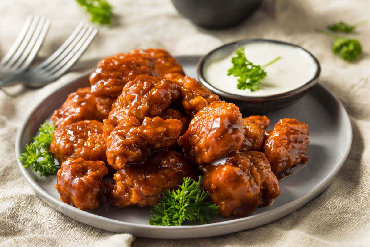 A file photo of a plate of boneless chicken wings and dipping sauce.