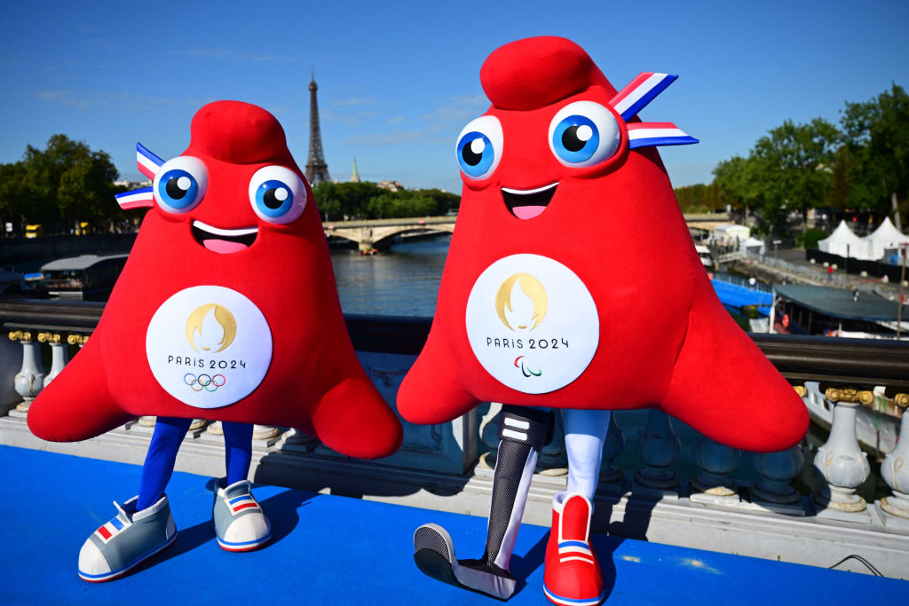 Olympic Phryges mascots pose for a photograph on the Alexandre III bridge with the Eiffel Tower in the background after the mixed relay of the 2023 World Triathlon- duathlon format of the Olympic Games Test Event in Paris, on August 20, 2023.