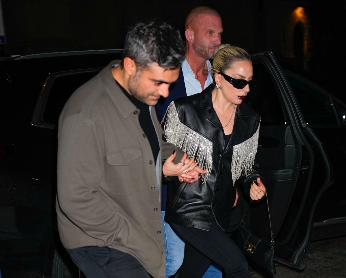 Lady Gaga and Michael Polansky hold hands.