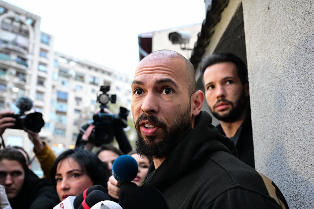 Andrew Tate (front) and his brother Tristan Tate (back R) speak to journalists after having been released from detention in Bucharest, Romania on March 12, 2024.