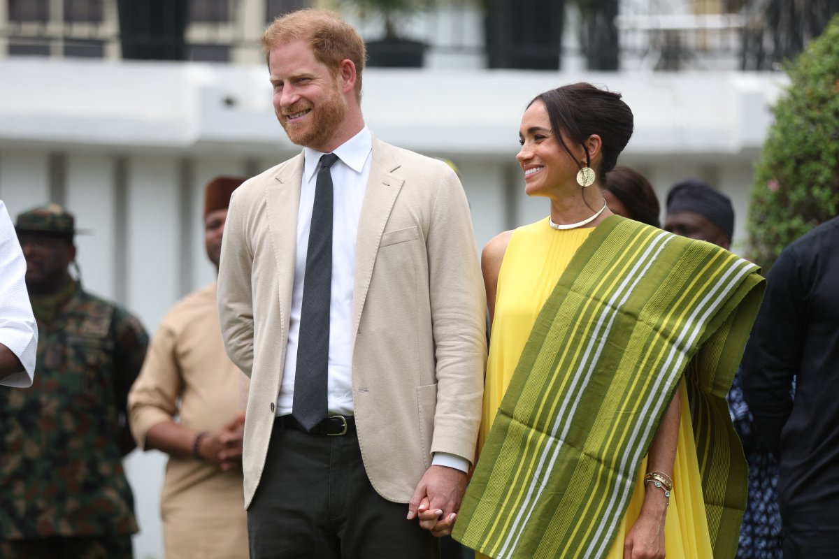 Britain's Prince Harry, Duke of Sussex, and Meghan Markle, Duchess of Sussex, react as Lagos State Governor, Babajide Sanwo-Olu (unseen), gives a speech at the State Governor House in Lagos on May 12, 2024 as they visit Nigeria as part of celebrations of Invictus Games anniversary.