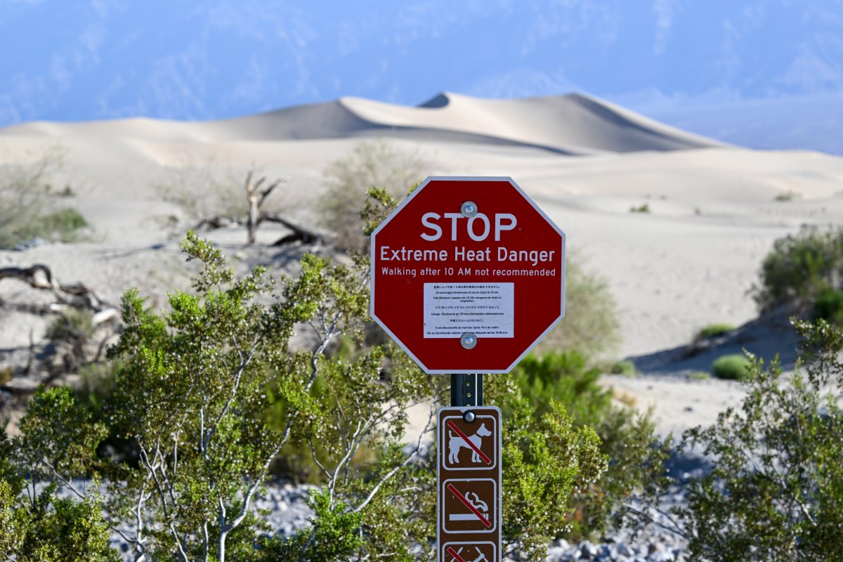 A sign that says 'Extreme Heat Danger' is seen near the Mesquite Flat Sand Dunes in Death Valley, California, United States on June 6, 2024.