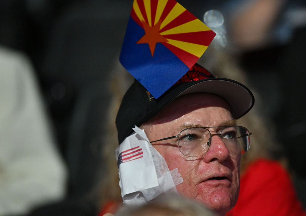 An attendee wears a bandage on his ear in solidarity with former president Donald Trump during Day 3 of the Republican National Convention on July 17, 2024 in Milwaukee, WI.