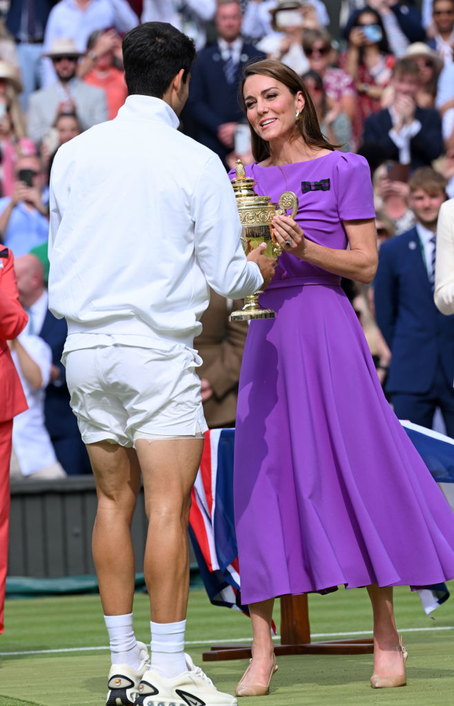 Catherine, Princess of Wales, presents the winner's trophy to Spain's Carlos Alcaraz (L) after beating Serbia's Novak Djokovic during their men's singles final tennis match on day fourteen of the Wimbledon Tennis Championships at the All England Lawn Tennis and Croquet Club on July 14, 2024 in London, England.
