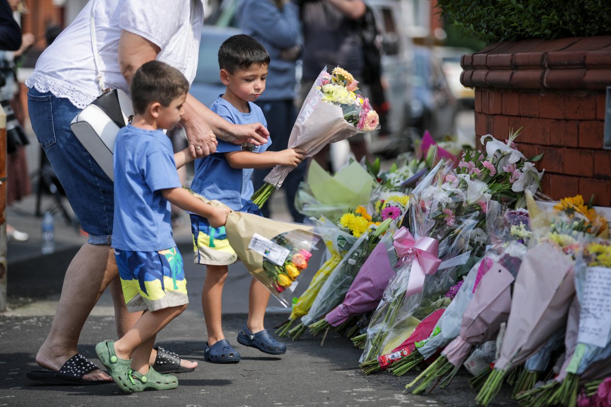 People lay flowers near the scene in Hart Street, Southport, where three children died and eight were injured in a "ferocious" knife attack during a Taylor Swift event at a dance school on Monday.