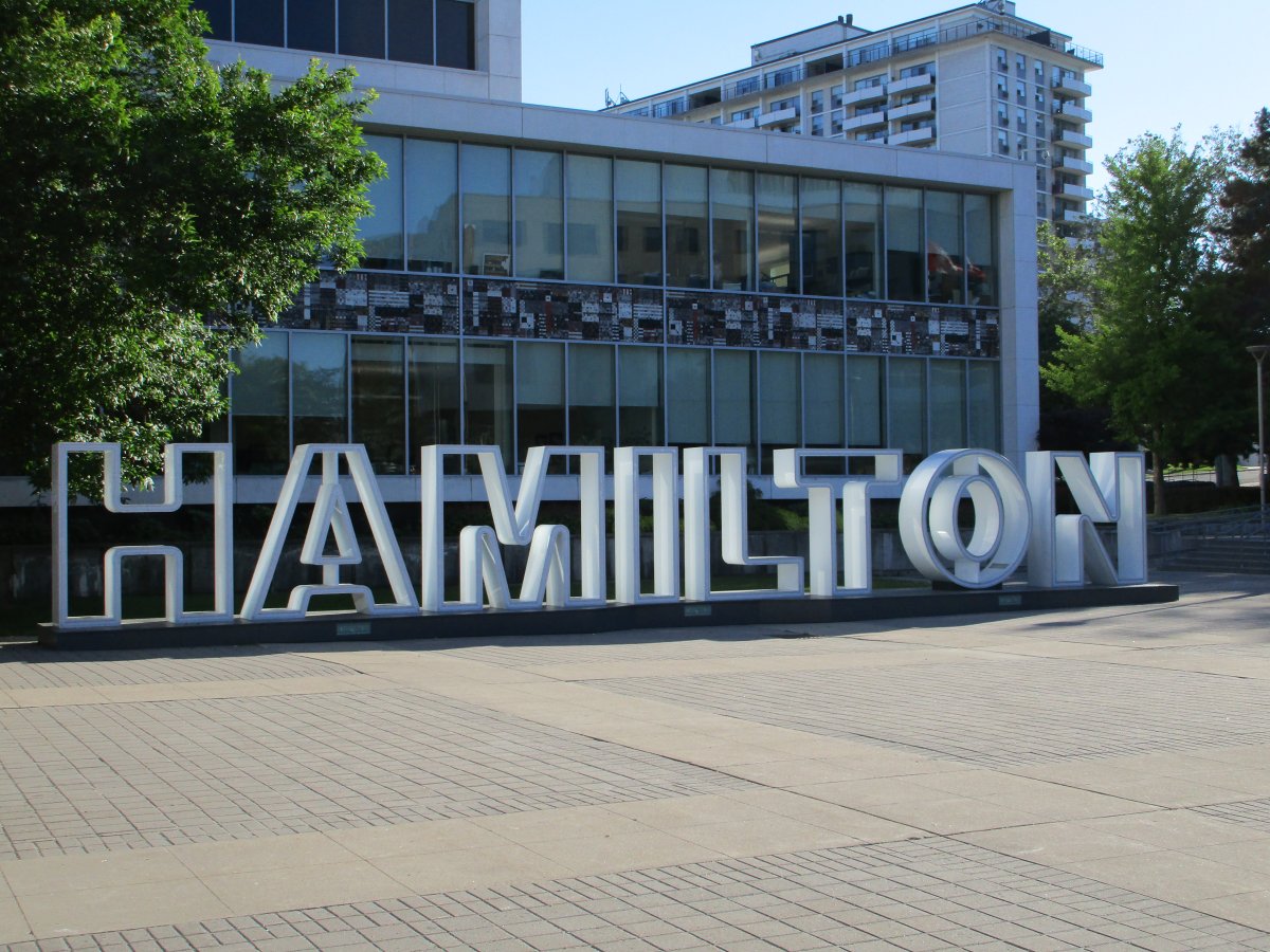 A photo of the Hamilton sign in front of city hall.