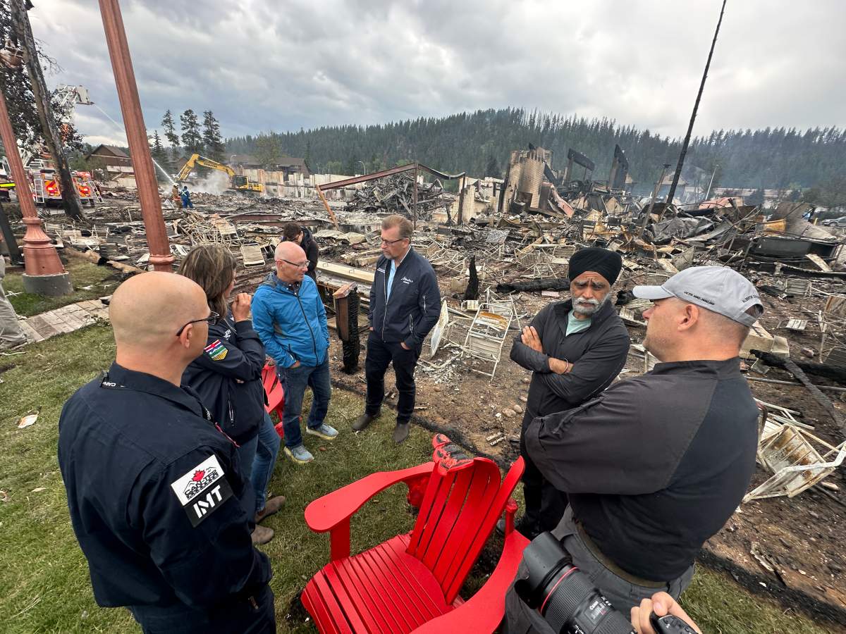 Premier Danielle Smith, Jasper Mayor Richard Ireland and Public Safety Minister Mike Ellis and Federal Emergency Preparedness Minister Harjit Sajjan observing wildfire damage in Jasper, Alta. on Friday, July 26, 2024.
