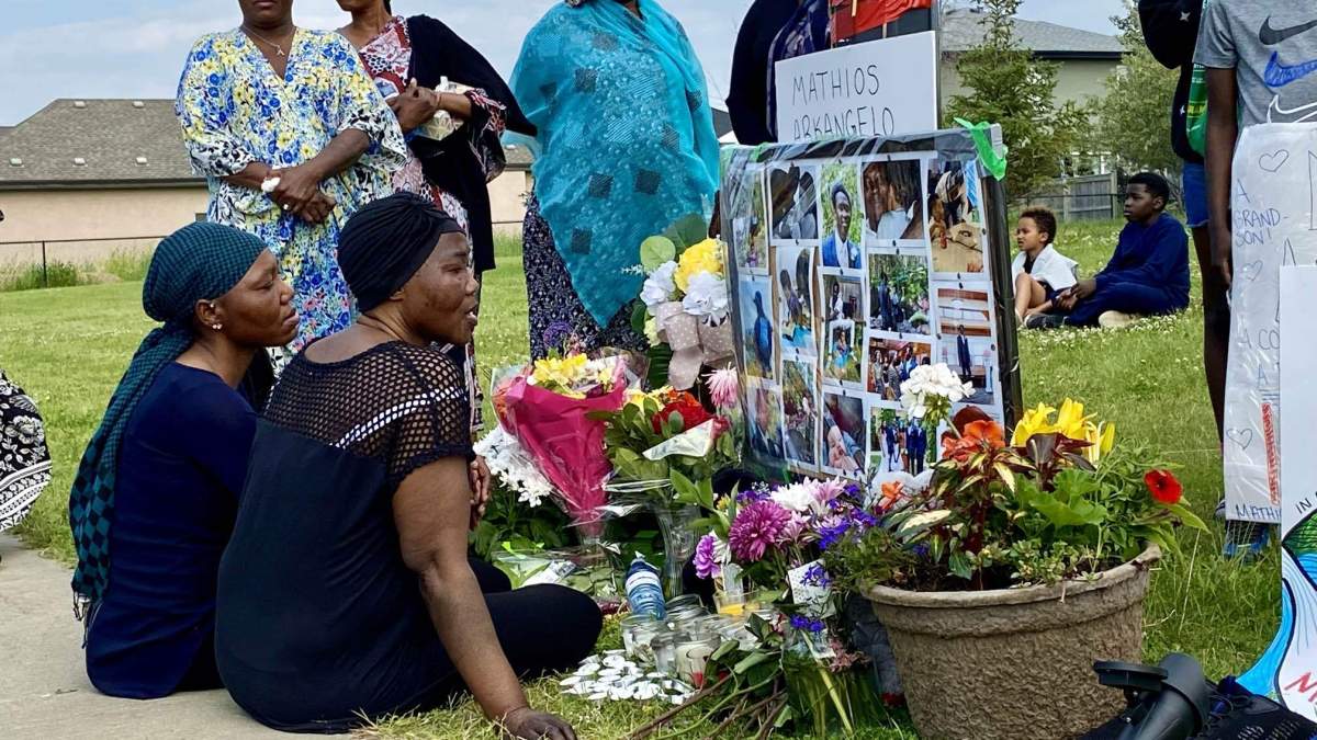 Anna Odo, Mathios Akrangelo’s mother, sits in front of a vigil set up in Fraser for the 28-year-old Edmonton man shot by police during a confrontation on Saturday, June 29, 2024.