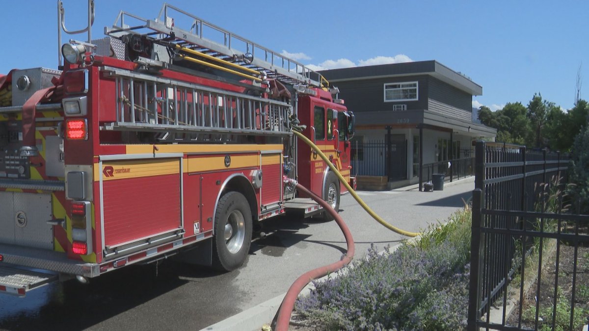 A fire truck is parked in front of an apartment building along the 2600 block of Highway 97 in Kelowna, B.C., on Friday, where a small fire inside a second-storey unit was extinguished.