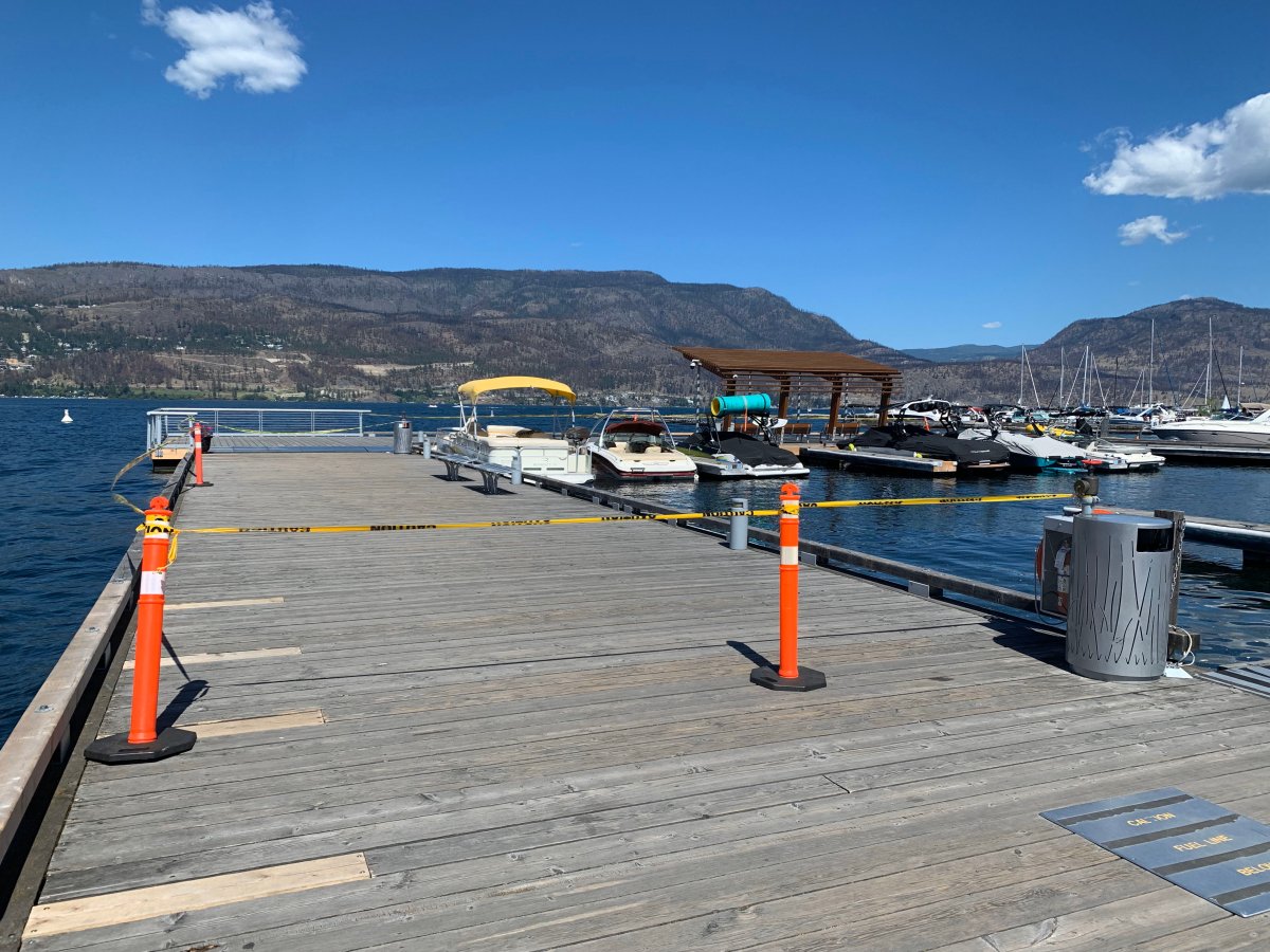 Police tape at a dock in downtown Kelowna, B.C., following a reported drowning early Saturday.