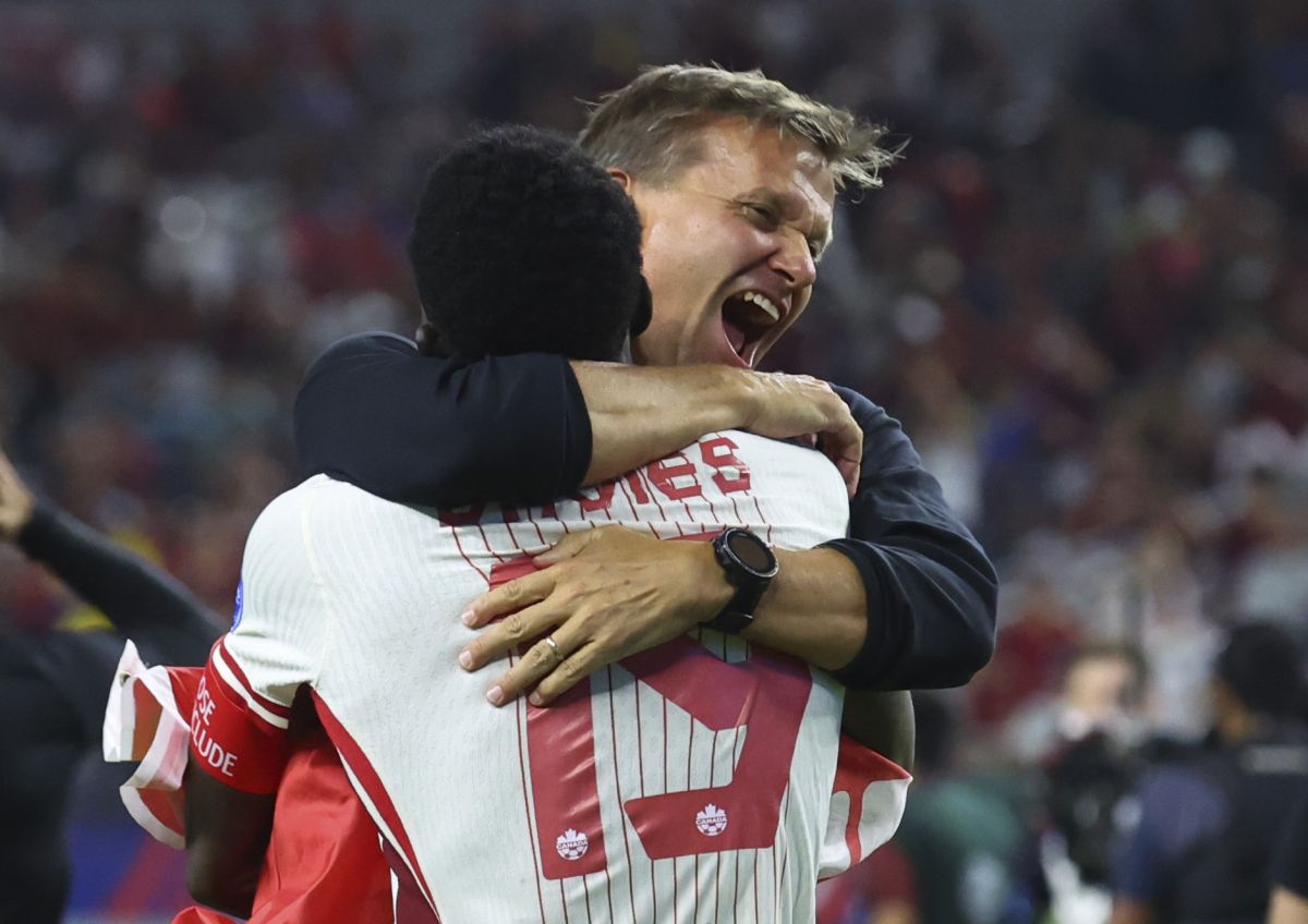 Canada defender Alphonso Davies (19) celebrates with head coach Jesse Marsch after their win over Venezuela in a Copa America quarterfinal soccer match in Arlington, Texas, Friday, July 5, 2024.