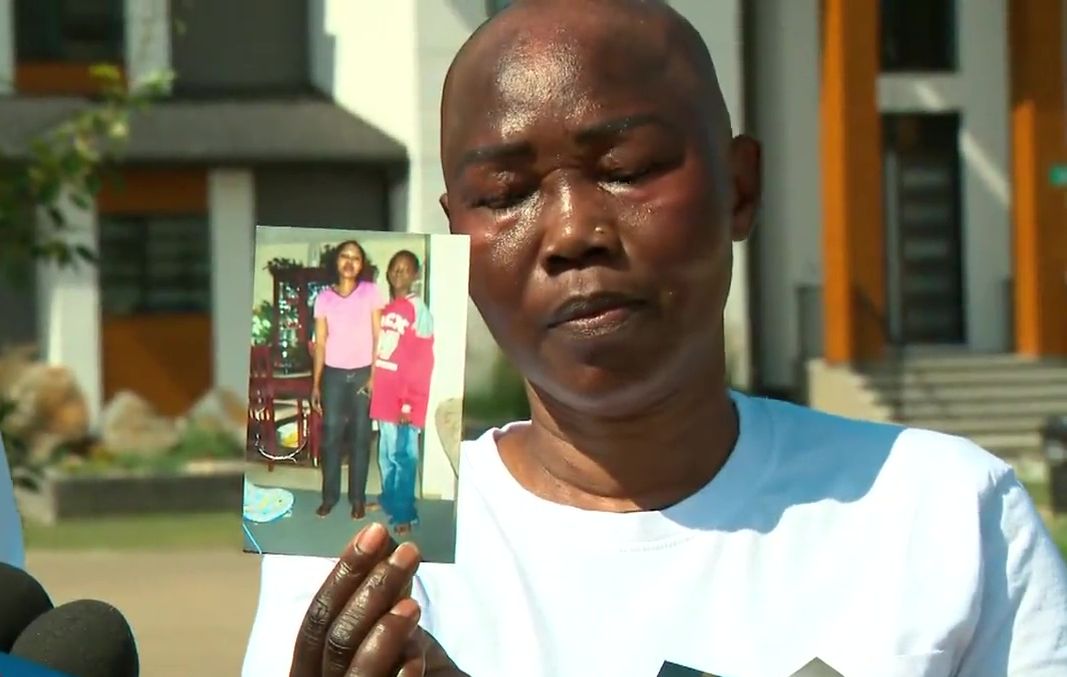 The grieving mother of Matt Arkangelo holds a photo of her son as a child at a news conference in Edmonton, Alta. on Tuesday, July 16, 2024.