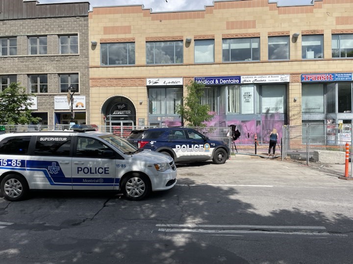 Police vehicles parked outside Miller's vandalized office.