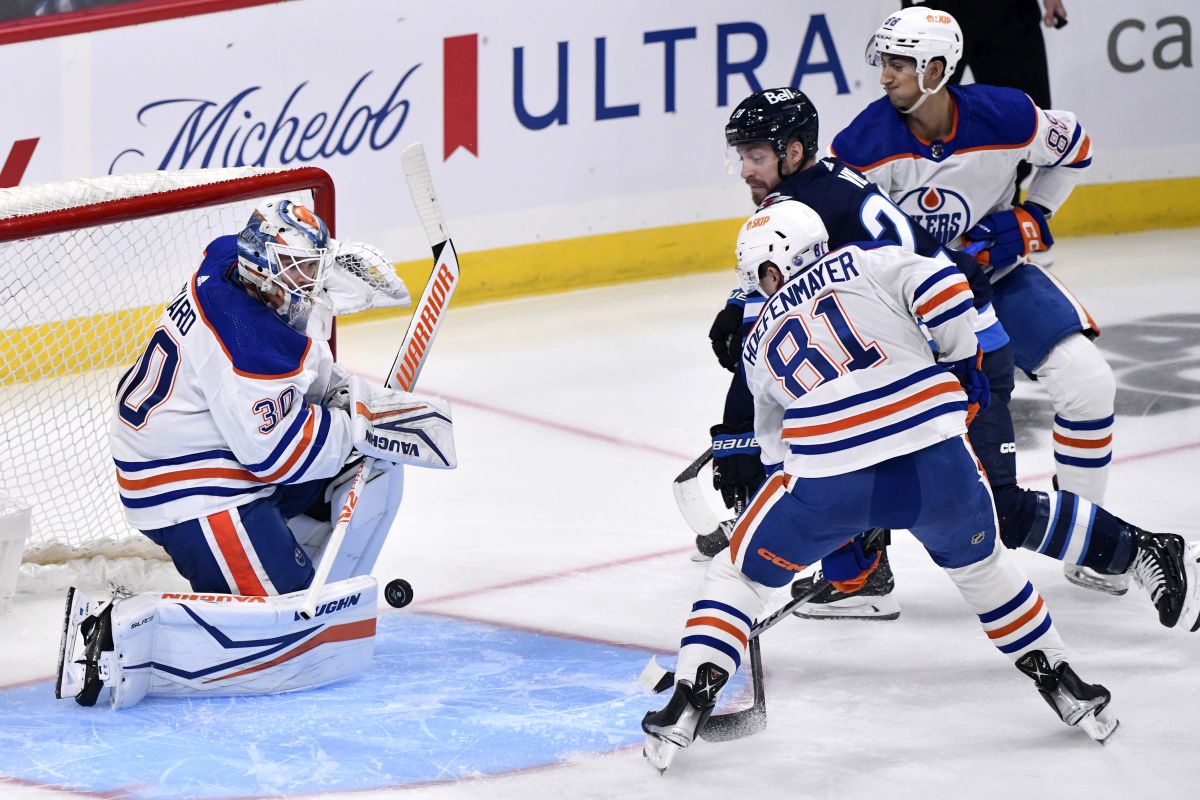Edmonton Oilers' goaltender Calvin Pickard (30) makes a save on Winnipeg Jets' Jeffrey Viel (28) as Noel Hoefenmayer (81) defends during first period NHL preseason action in Winnipeg on Monday September 25, 2023.
