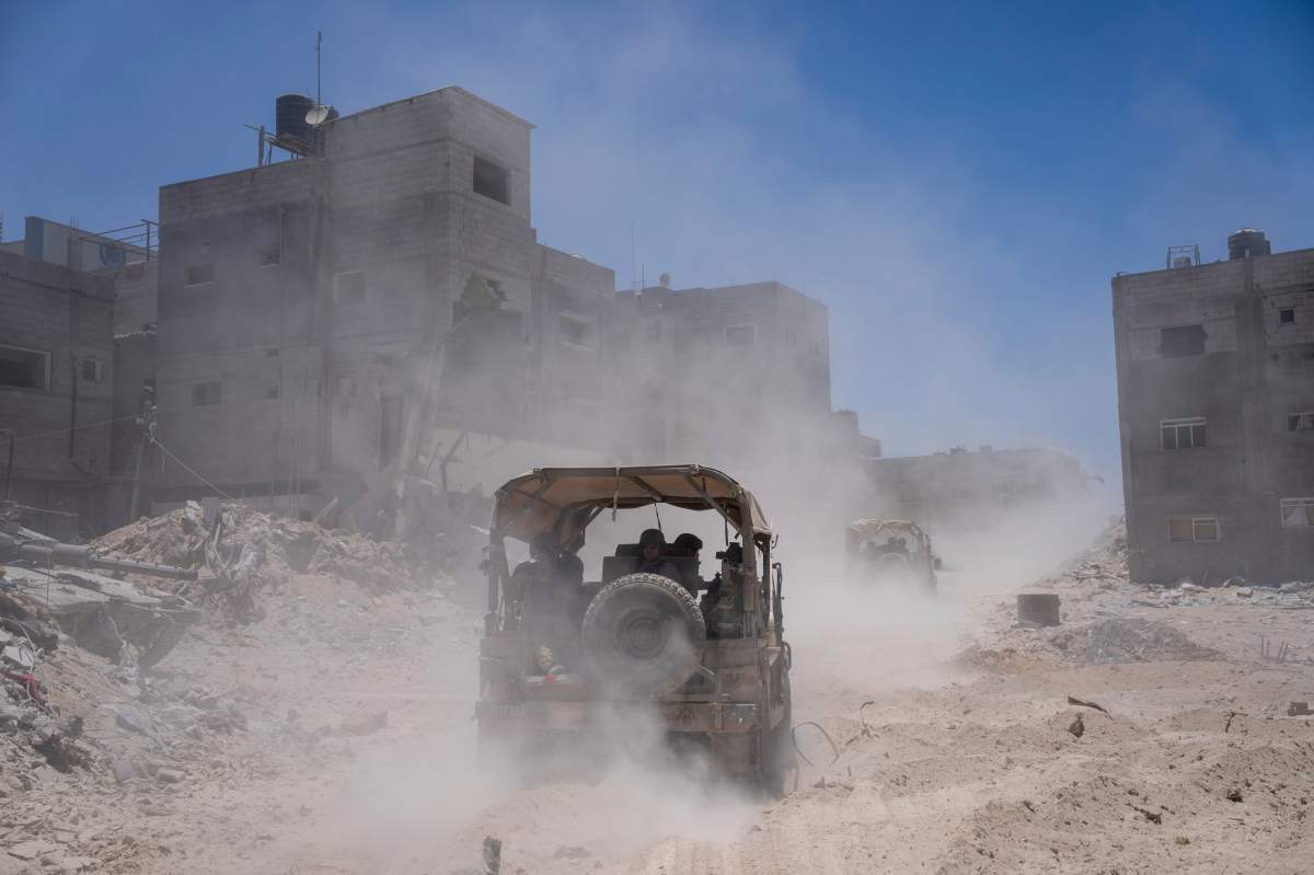 Israeli army vehicles transport a group of soldiers and journalists inside the southern Gaza Strip, Wednesday, July 3, 2024. The Israeli military invited reporters for a tour of Rafah, where the military has been operating since May 6. (AP Photo/Ohad Zwigenberg, Pool)