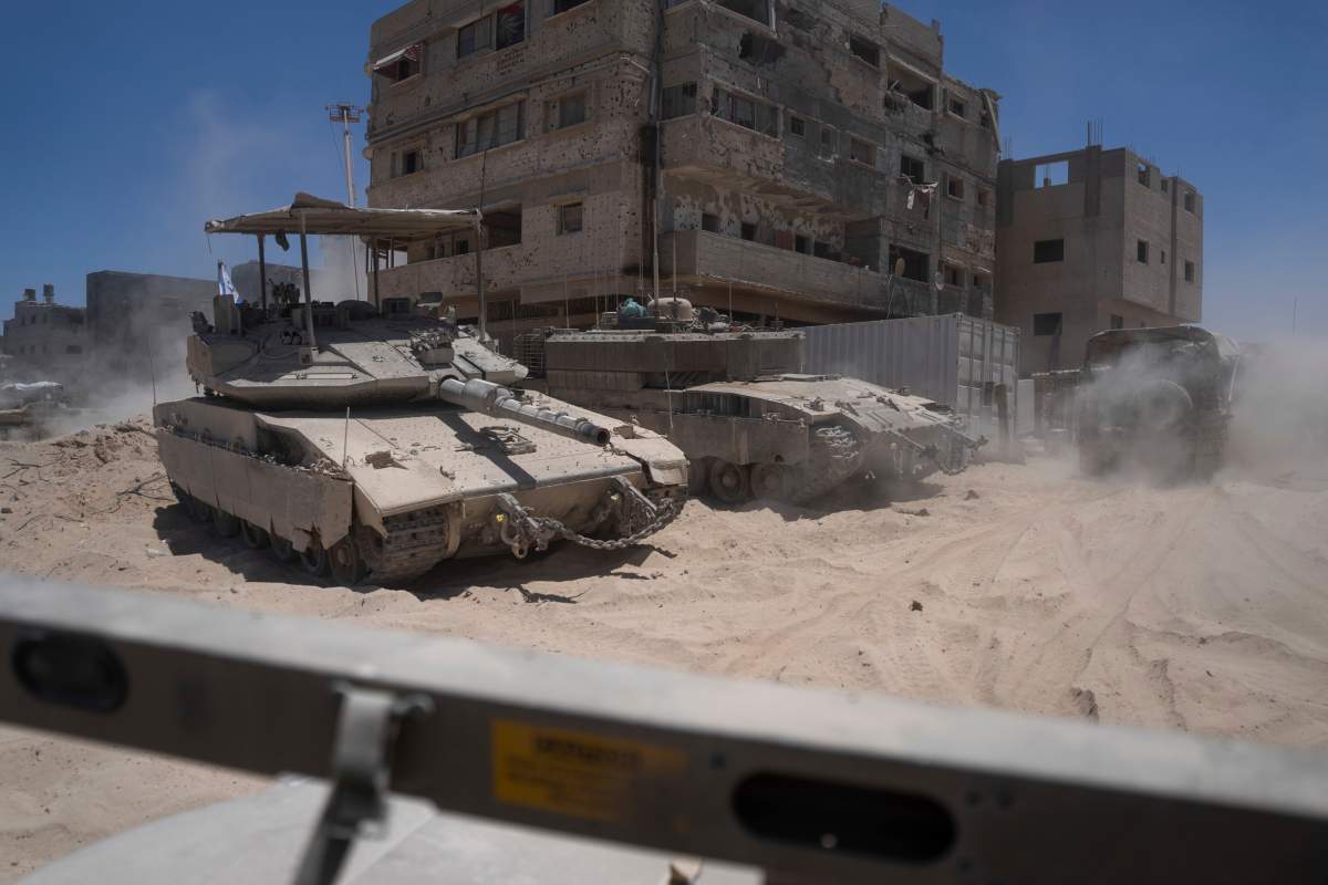 Israeli tanks are seen next to destroyed buildings in the southern Gaza Strip