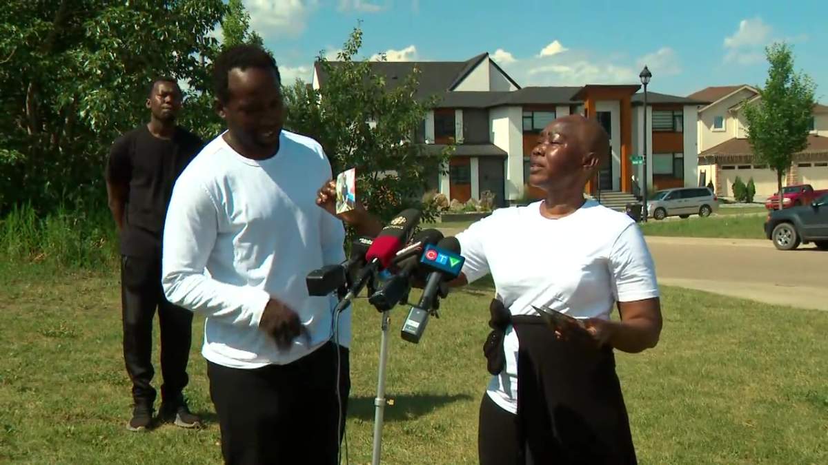 The grieving mother of Matt Arkangelo holds a photo of her son as a child at a news conference in Edmonton, Alta. on Tuesday, July 16, 2024.