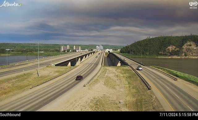A southbound traffic camera image from Highway 63 and Memorial Bridge in Fort McMurray showing wildfire smoke moving in on Thursday, July 11, 2024.
