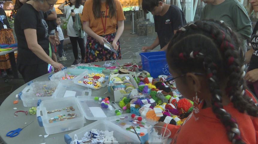 Photo of people doing crafts at a Canada Day celebration in Winnipeg