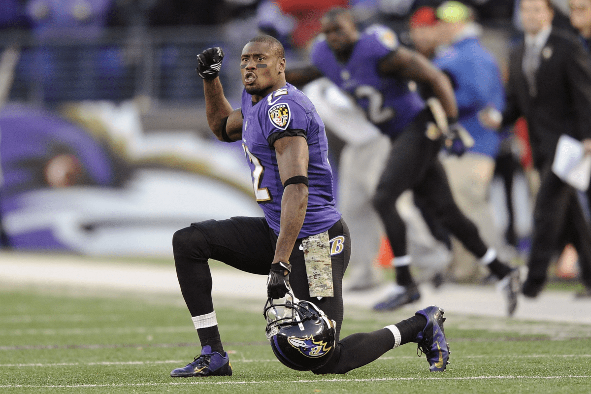 Jacoby Jacobs on one knee in an NFL Baltimore Ravens uniform.