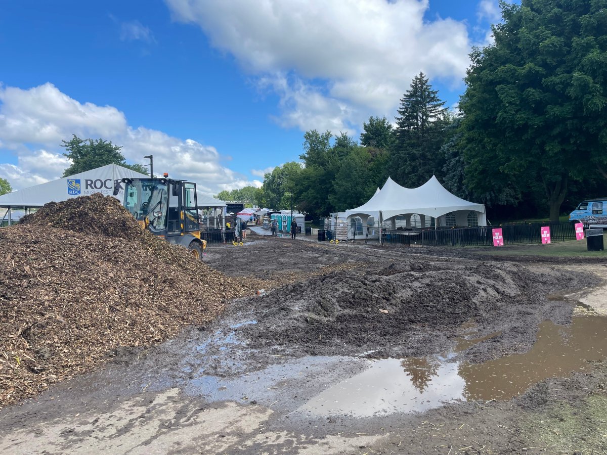 A pile of woodchips in front of tents at a park.