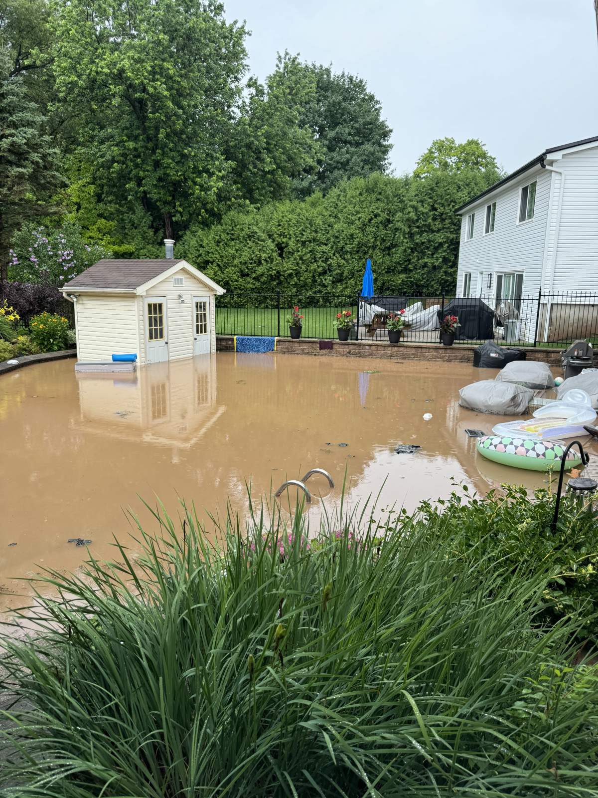 Photo of a flooded backyard July 16, 2024 on Cavendish Drive in Burlington Ontario. At least a dozen residents in a neighborhood near the 407 had their homes partially submerged after two days of intense rainfall.