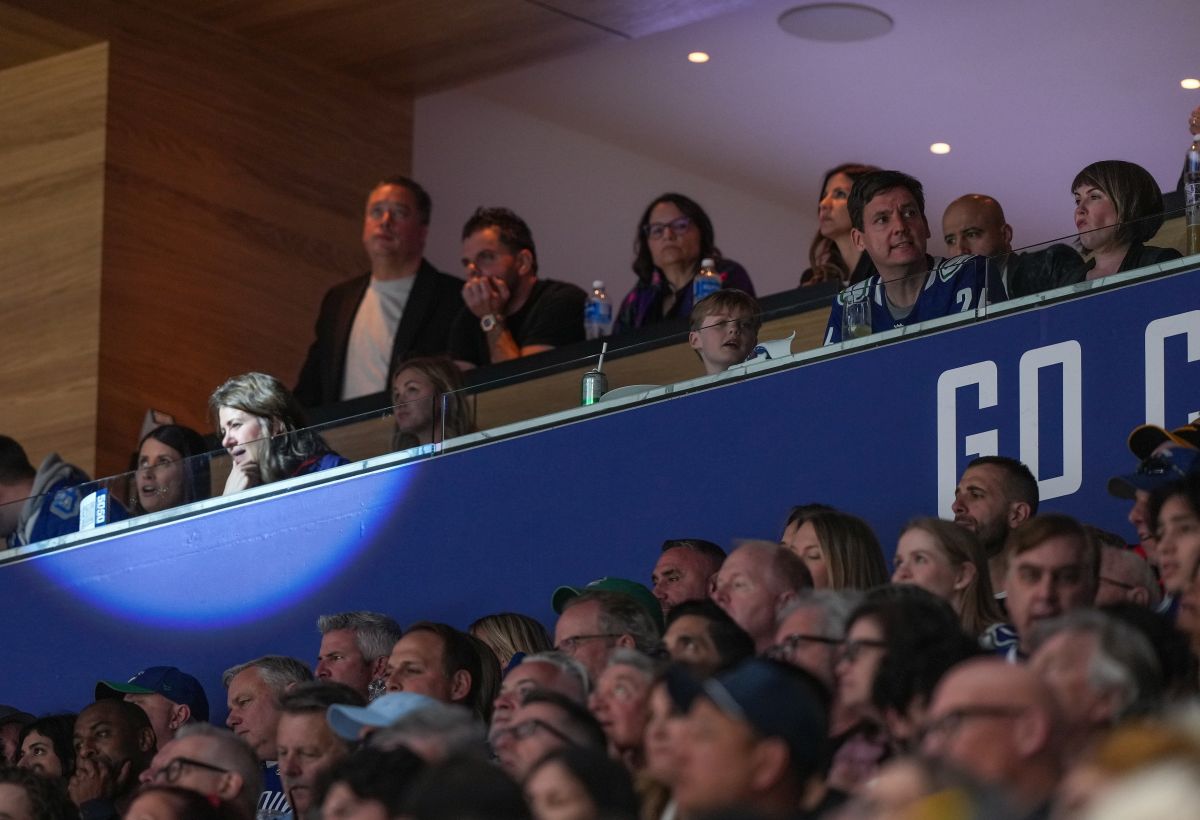 Alberta Premier Danielle Smith, front second left, and B.C. Premier David Eby, front second right, watch the Vancouver Canucks and Edmonton Oilers play Game 2 of an NHL hockey Stanley Cup second-round playoff series, in Vancouver, on Friday, May 10, 2024.