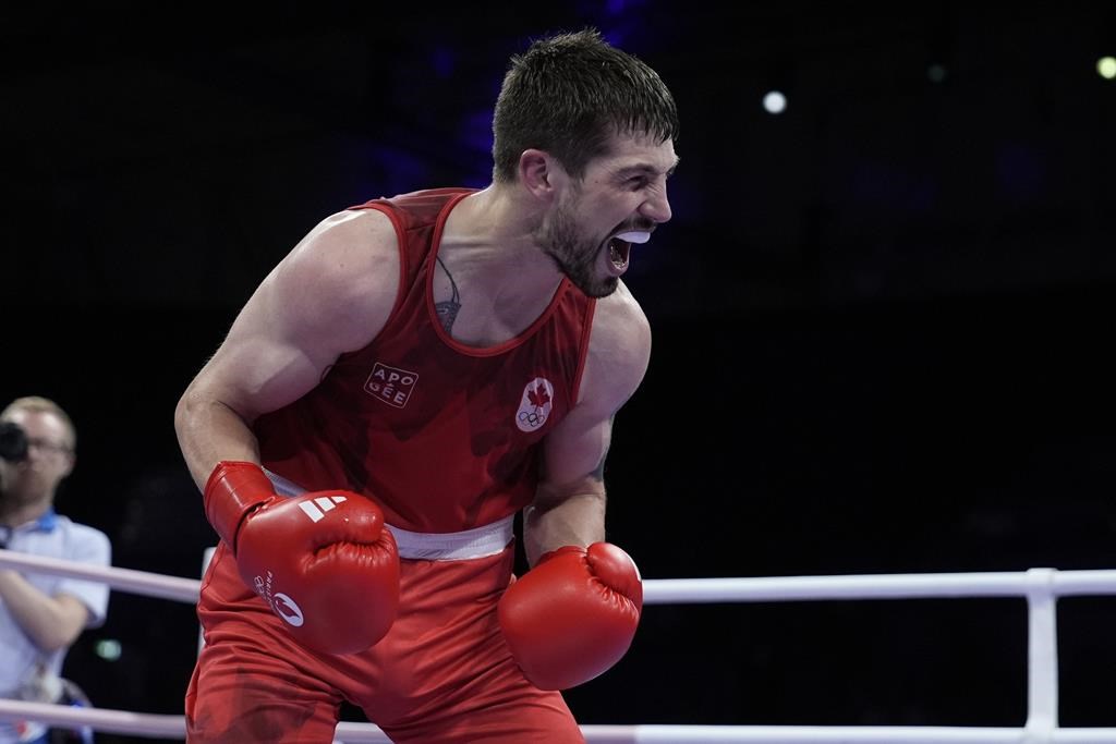 Canada's Wyatt Sanford celebrates after defeating Uzbekistan's Ruslan Abdullaev in their men's 63.5-kg quarterfinal boxing match at the 2024 Summer Olympics, Aug. 1, in Paris, France. THE CANADIAN PRESS/AP, John Locher.