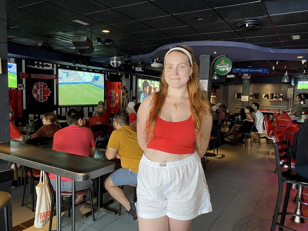 Tami Piovesan, a fan of Canadian women’s soccer, joined others gathered at Bar St-Laurent Frappe to watch their team take on Germany in the quarterfinals of the Paris Olympic Games, in Montreal, Saturday, Aug. 3, 2024. Despite the heartbreak of seeing the reigning champions lose 4-2 on penalties and some tournament controversy they had plenty of reason to cheerful about. THE CANADIAN PRESS/Joe Bongiorno.