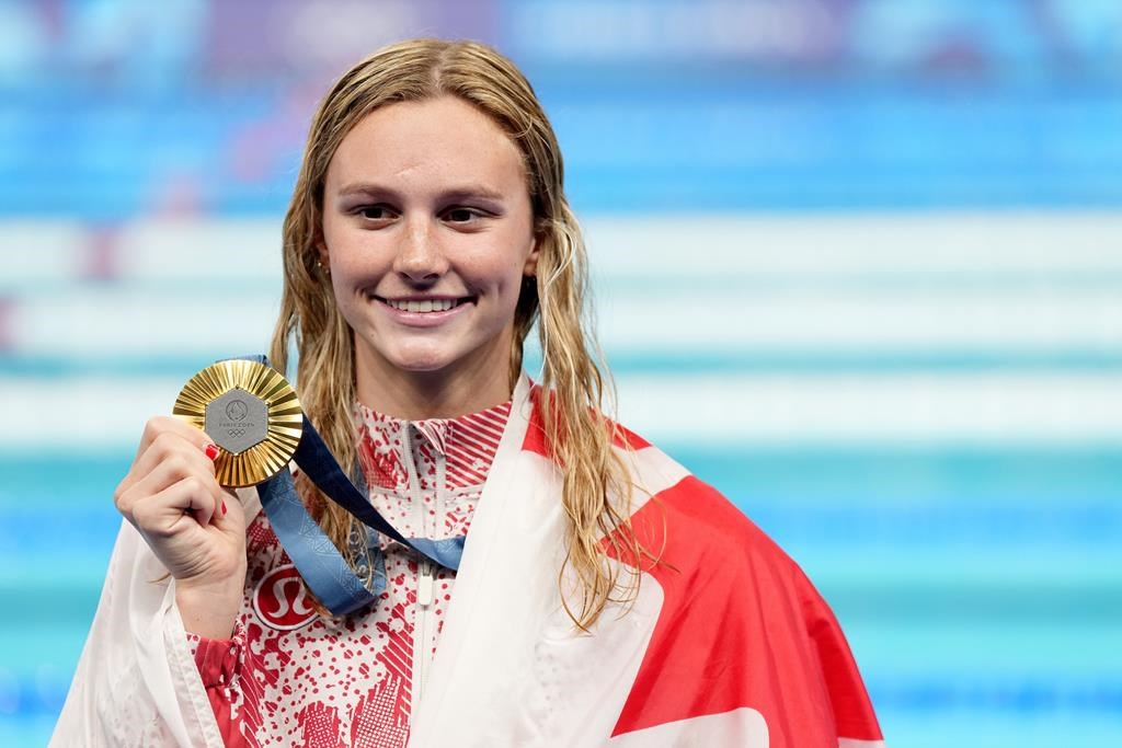 Canada's Summer McIntosh, of Toronto, celebrates with her gold medal won in the 200m women's individual medley final during the 2024 Summer Olympic Games, in Nanterre, France, Saturday, Aug. 3, 2024. THE CANADIAN PRESS/Christinne Muschi.