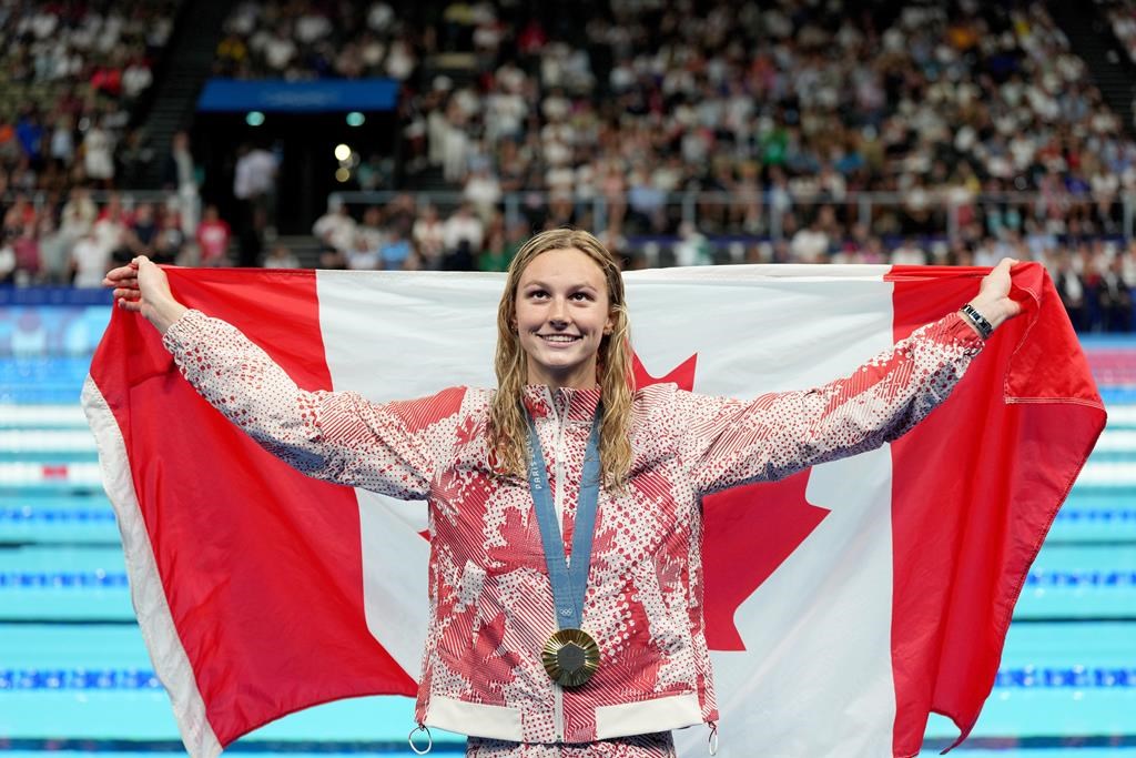 Canada's Summer McIntosh, of Toronto, celebrates with her gold medal won in the 200m women's individual medley final during the 2024 Summer Olympic Games, in Nanterre, France, Saturday, Aug. 3, 2024. THE CANADIAN PRESS/Christinne Muschi.