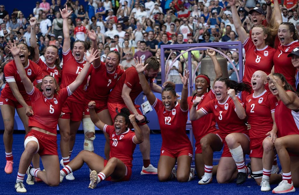 Team Canada celebrates during a team photo after defeating Australia in rugby sevens semi-inal action at the Summer Olympics, Tuesday, July 30, 2024 in Paris. Canada's team in Paris is on pace for a record Olympic Games at halftime after a mortifying soccer scandal that began before the flameless eco-flame was even lit in Jardin des Tuileries. THE CANADIAN PRESS/Adrian Wyld.