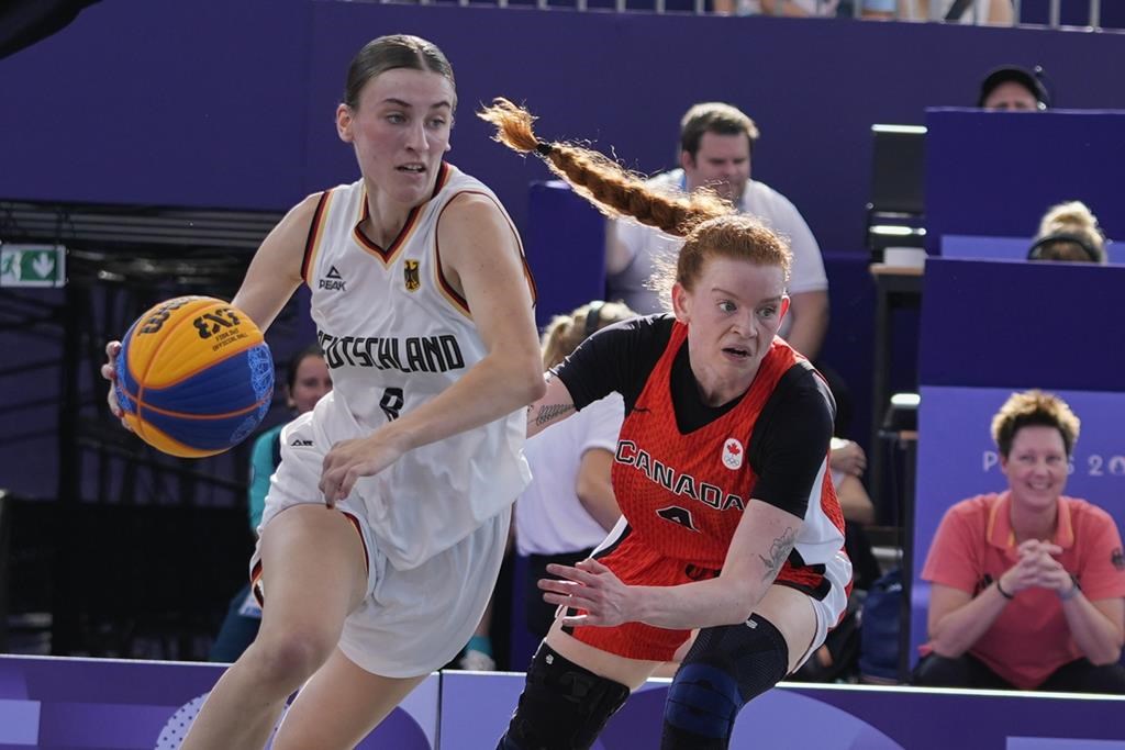 Germany's Elisa Mevius (8) drives past Canada's Kacie Bosch (4) in the women's 3x3 basketball pool round match during the 2024 Summer Olympics, Thursday, Aug. 1, 2024, in Paris, France. THE CANADIAN PRESS/AP/Frank Franklin II.