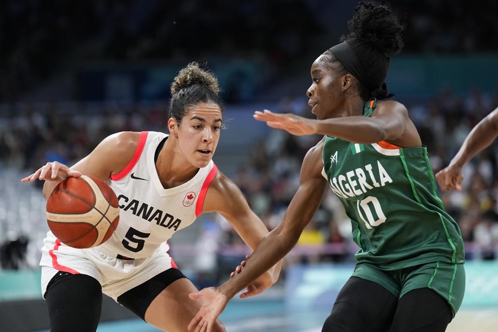 Kia Nurse (5), of Canada, drives around Promise Amukamara (10), of Nigeria, in a women's basketball game at the 2024 Summer Olympics, Sunday, Aug. 4, 2024, in Villeneuve-d'Ascq, France. THE CANADIAN PRESS/AP/Mark J. Terrill.