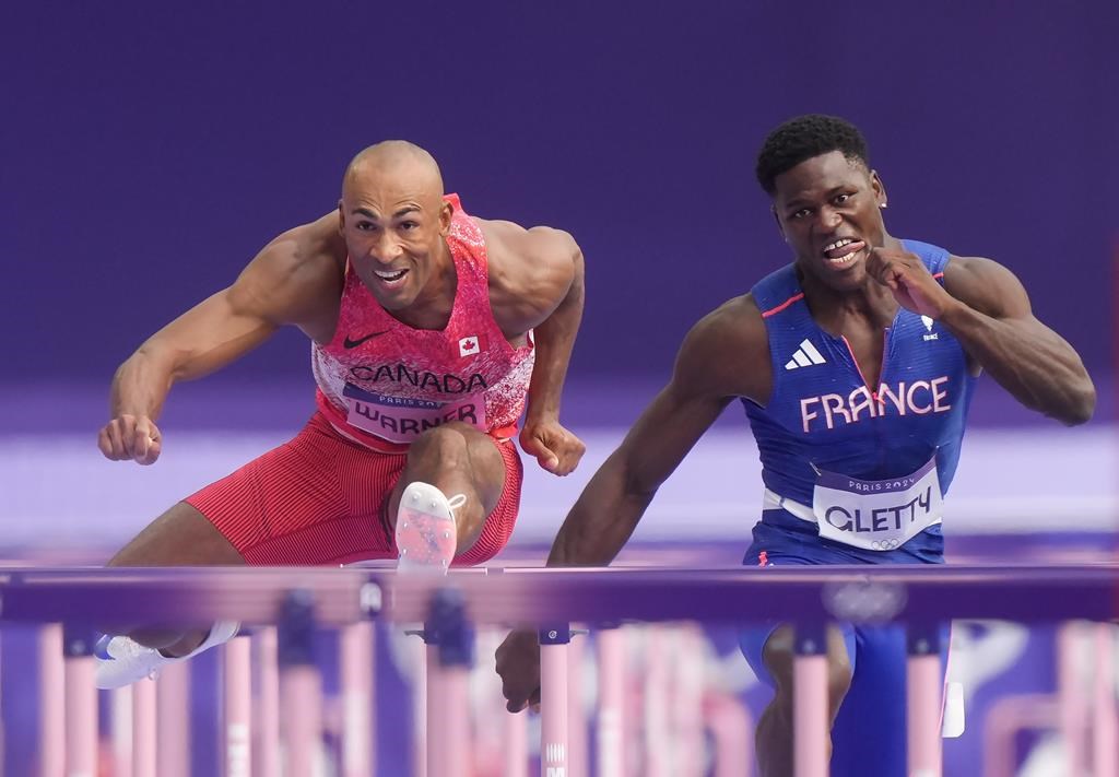 Canada's Damian Warner, left, competes in the men's 110m hurdles in the decathlon at the Paris Summer Olympics in Paris, France on Saturday, August 3, 2024. THE CANADIAN PRESS/Nathan Denette.