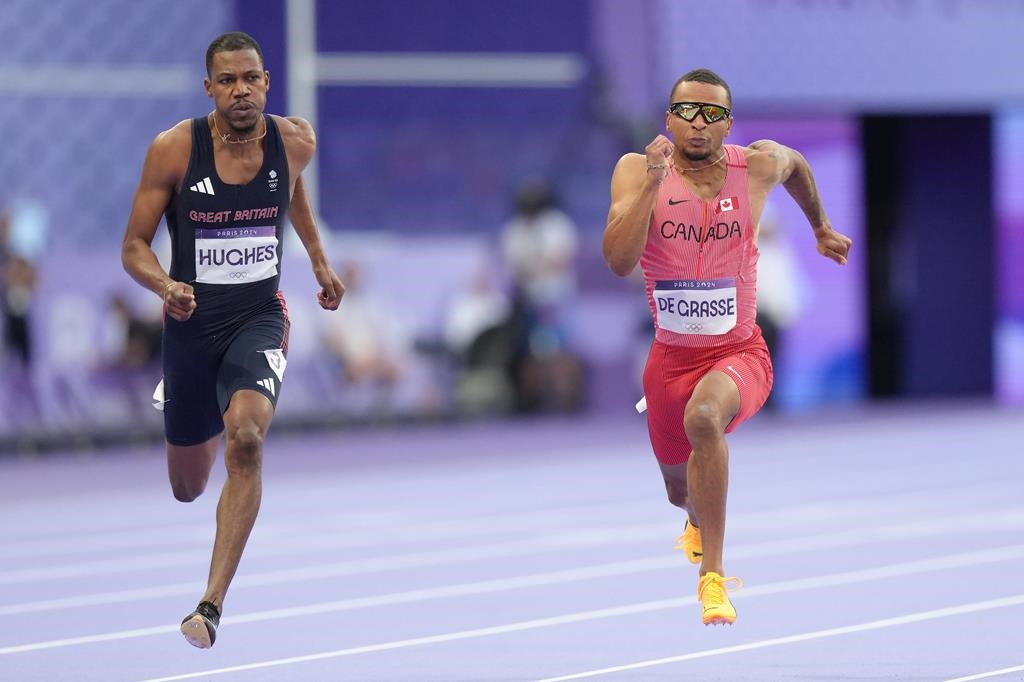 Sprinter Andre De Grasse, of Markham, Ont., right, competes in the men’s 100m semi-finals at the 2024 Summer Olympics, Sunday, Aug. 4, 2024, in Saint-Denis, France. THE CANADIAN PRESS/Nathan Denette.