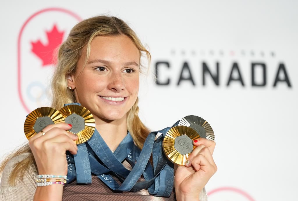 Canada's Summer McIntosh of Toronto poses with her four medals won in the pool at the 2024 Summer Olympics, Monday, Aug. 5, 2024 in Paris, France. The three gold medals were for the 200m Butterfly, the 200m Individual Medley and the 400m Individual Medley and the one silver was for the 400m Freestyle. THE CANADIAN PRESS/Christinne Muschi


.