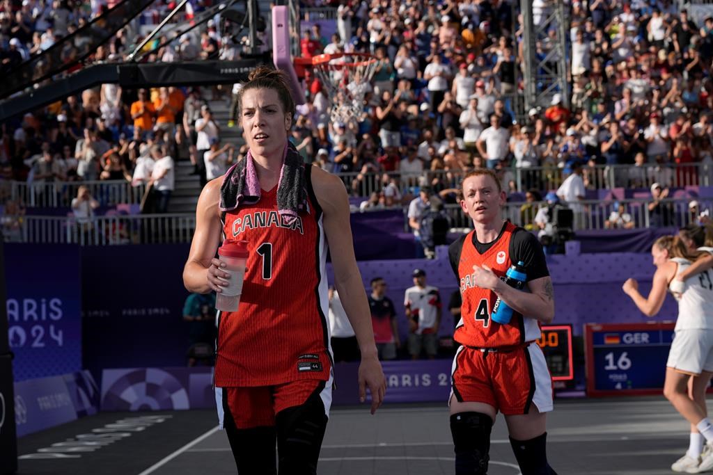 Canada's Michelle Plouffe (1) and Kacie Bosch (4) walk off the court after their women's 3 X 3 basketball semifinal loss to Germany at the Summer Olympics in Paris on Monday, Aug.5, 2024. THE CANADIAN PRESS/Adrian Wyld.