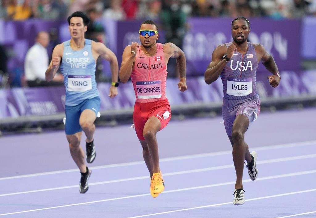 Canada's Andre De Grasse, centre, of Markham, Ont., competes in the men’s 200m qualifying heat at the 2024 Summer Olympics, Monday, Aug. 5, 2024, in Saint-Denis, France. The 29-year-old crossed the finish line in 20.30 seconds to finish second in Heat 6. THE CANADIAN PRESS/Christinne Muschi




.