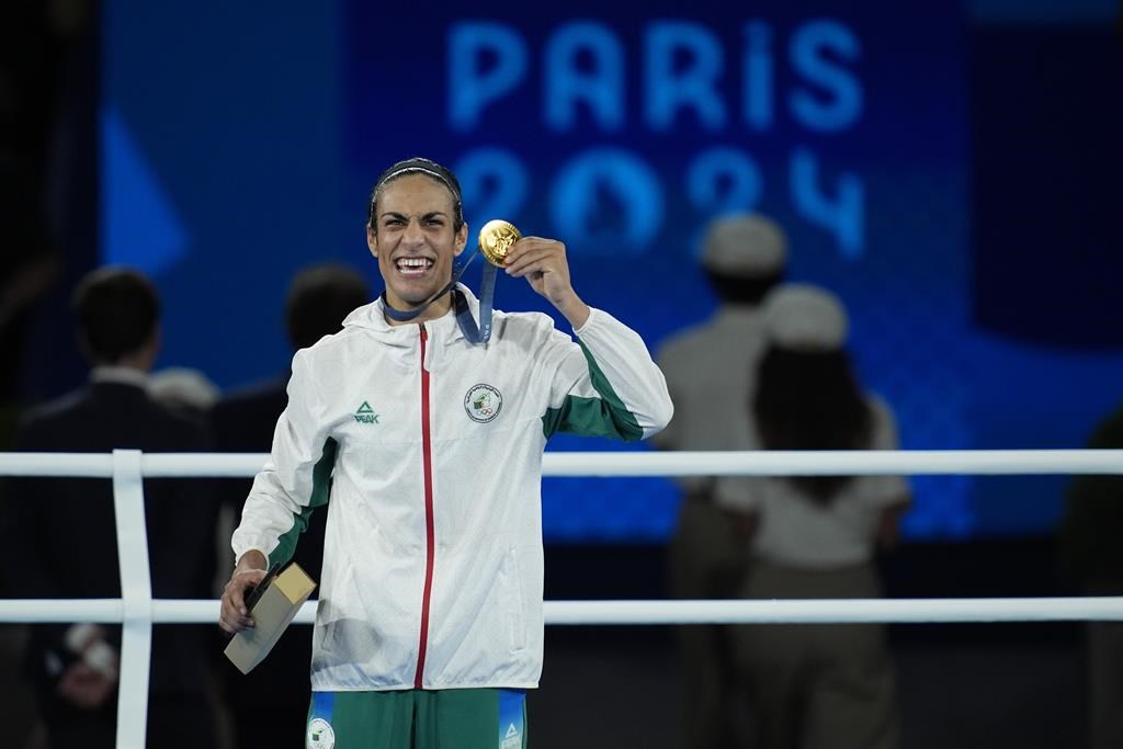 Gold medalist Algeria's Imane Khelif poses during a medals ceremony for the women's 66 kg final boxing match at the 2024 Summer Olympics, Friday, Aug. 9, 2024, in Paris, France.