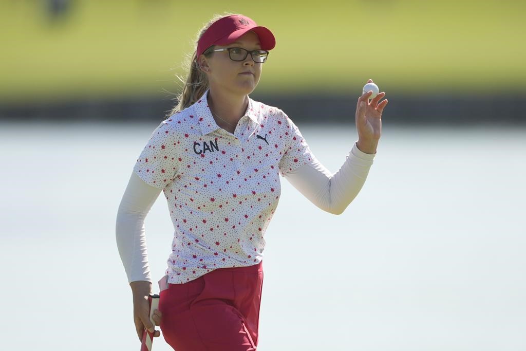 Brooke Henderson, of Canada, acknowledges the crowd after putting on the 18th green during the final round of the women's golf event at the 2024 Summer Olympics, Saturday, Aug. 10, 2024, at Le Golf National, in Saint-Quentin-en-Yvelines, France. THE CANADIAN PRESS/AP-Matt York.