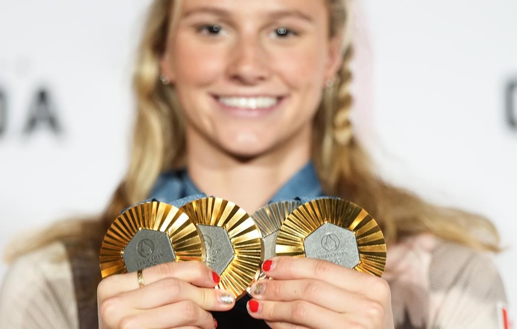 Canada's Summer McIntosh of Toronto poses with her four medals won in the pool at the 2024 Summer Olympics, Monday, Aug. 5, 2024 in Paris, France. The three gold medals were for the 200m Butterfly, the 200m Individual Medley and the 400m Individual Medley and the one silver was for the 400m Freestyle. THE CANADIAN PRESS/Christinne Muschi.